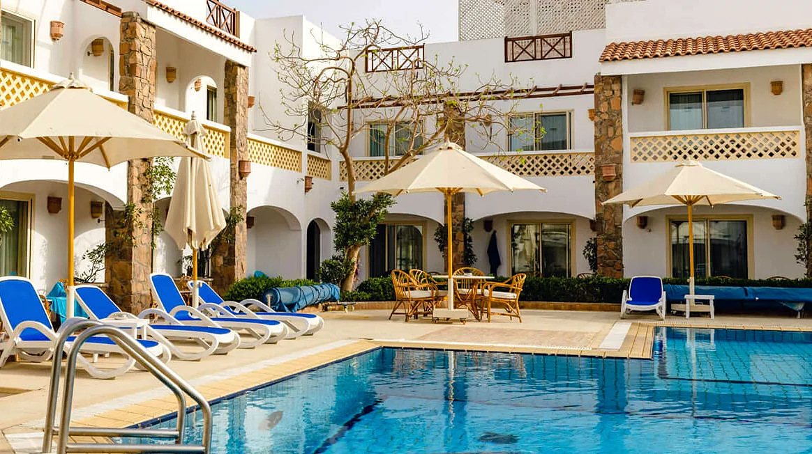 Hotel rooms and a pool around a courtyard
