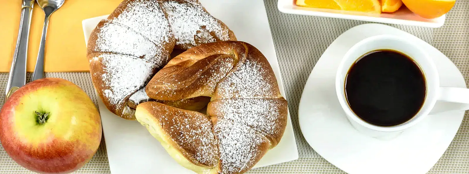 Pastries and coffee on a breakfast table